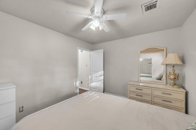 bedroom with baseboards, visible vents, and ceiling fan