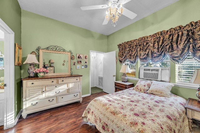 bedroom featuring baseboards, cooling unit, wood finished floors, and a ceiling fan