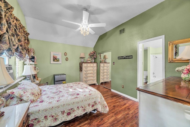 bedroom featuring dark wood finished floors, lofted ceiling, baseboards, visible vents, and ceiling fan