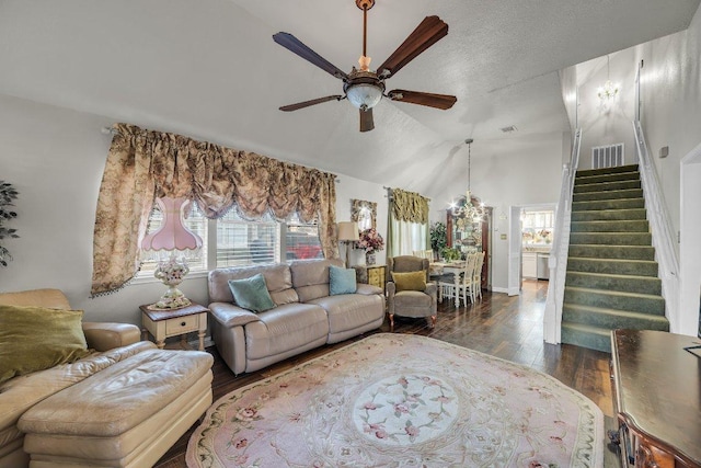 living area with lofted ceiling, stairs, wood-type flooring, visible vents, and ceiling fan
