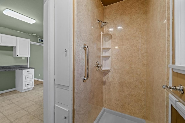 bathroom featuring visible vents and tiled shower