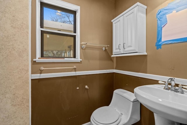 half bath with a sink and toilet