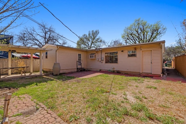 back of property featuring a patio, fence, and a lawn