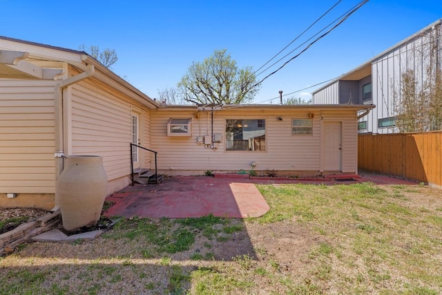 back of house with a patio area, a lawn, and fence