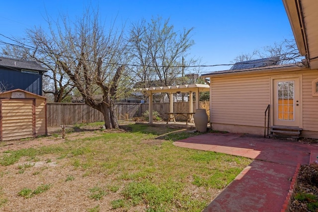 view of yard featuring an outbuilding, a patio, a shed, a fenced backyard, and entry steps