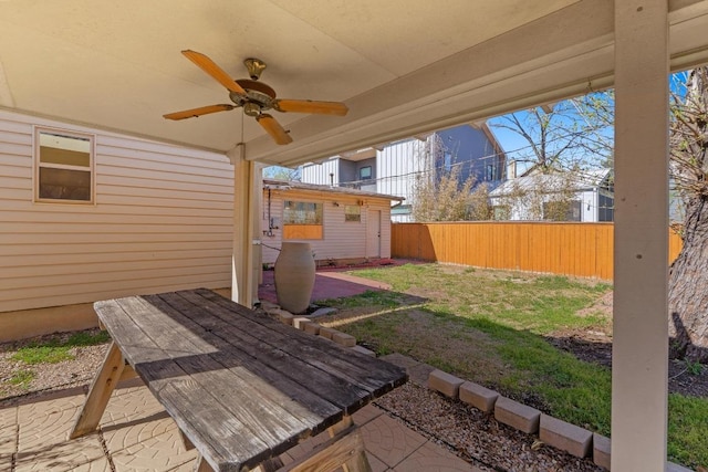 view of patio featuring a ceiling fan and fence