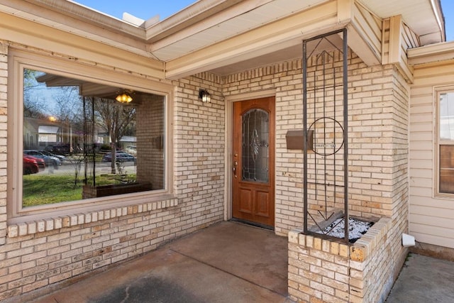 property entrance featuring brick siding