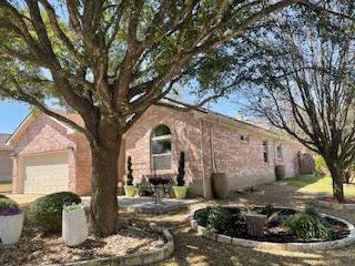 view of front of house featuring brick siding and an attached garage