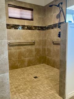 full bathroom with tiled shower