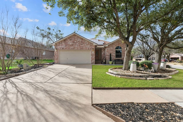 ranch-style house featuring driveway, a front yard, a garage, brick siding, and solar panels