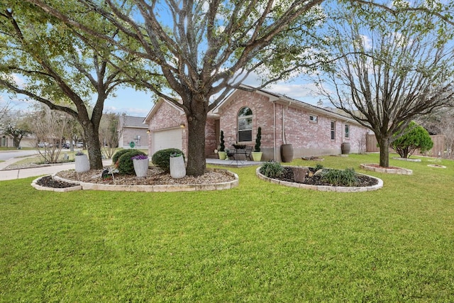 view of front of house with brick siding, an attached garage, and a front lawn