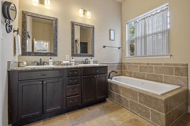 10033 Longhorn Skwy, Dripping Springs, TX 78620 - full bathroom with double vanity, a bath, and stone finish flooring