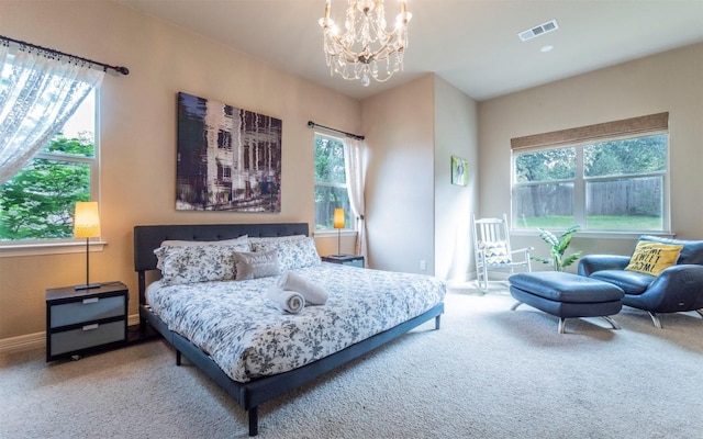 10033 Longhorn Skwy, Dripping Springs, TX 78620 - carpeted bedroom with a chandelier, multiple windows, and baseboards