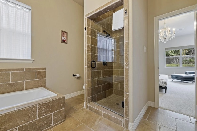 10033 Longhorn Skwy, Dripping Springs, TX 78620 - bathroom featuring stone tile flooring, a stall shower, connected bathroom, a garden tub, and baseboards