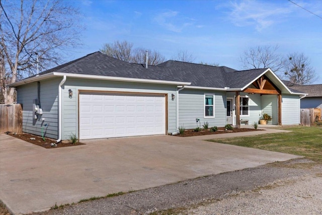 single story home featuring a garage, driveway, and fence