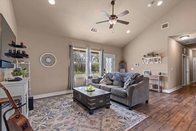 living area with hardwood / wood-style floors, visible vents, baseboards, and ceiling fan