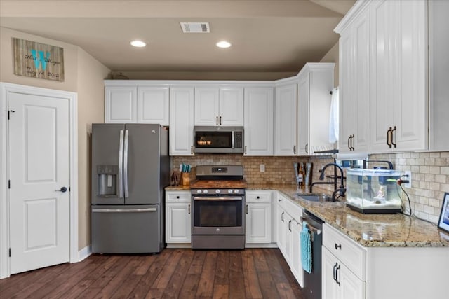 kitchen with visible vents, white cabinets, appliances with stainless steel finishes, and a sink