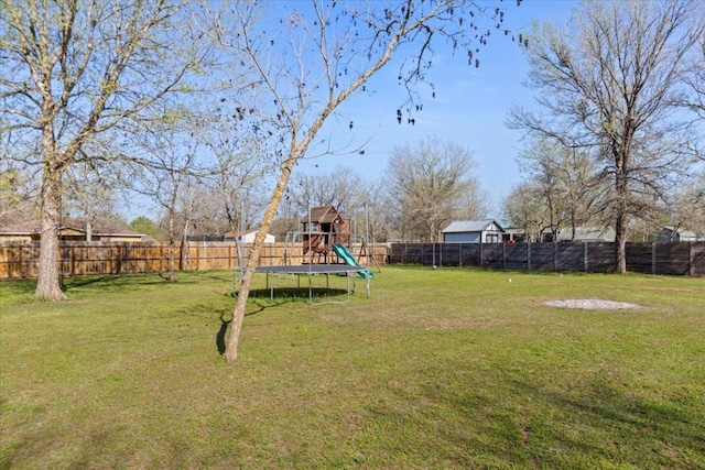 view of yard with a playground and a fenced backyard