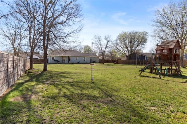 view of yard with a playground and a fenced backyard