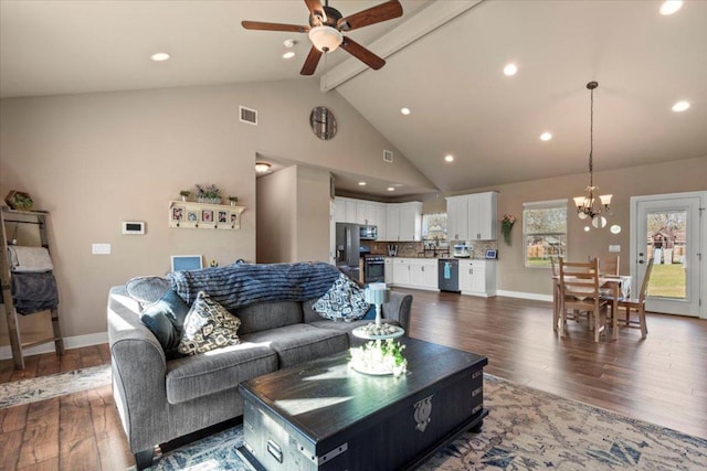 living room with visible vents, beamed ceiling, ceiling fan with notable chandelier, high vaulted ceiling, and dark wood-style flooring