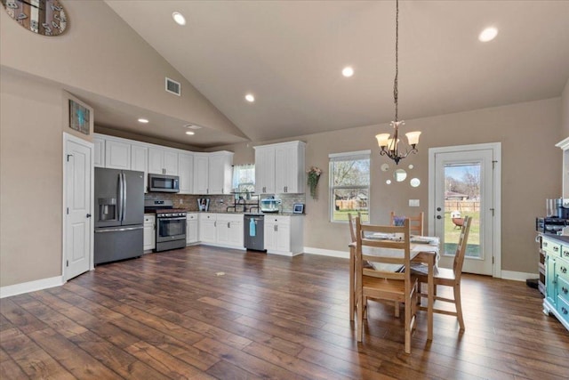 dining space featuring visible vents, baseboards, an inviting chandelier, dark wood-style floors, and high vaulted ceiling