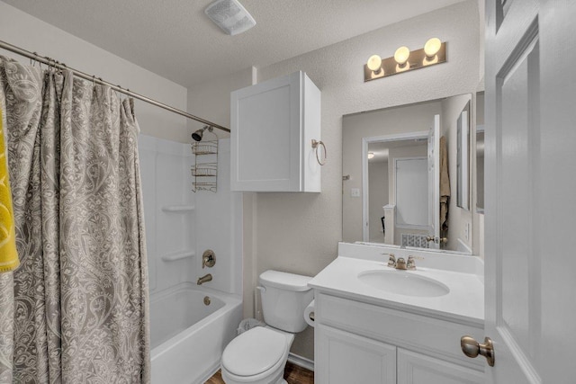 full bathroom featuring vanity, visible vents, a textured ceiling, toilet, and a textured wall