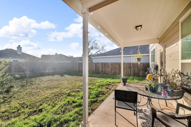 view of patio featuring outdoor dining space and a fenced backyard