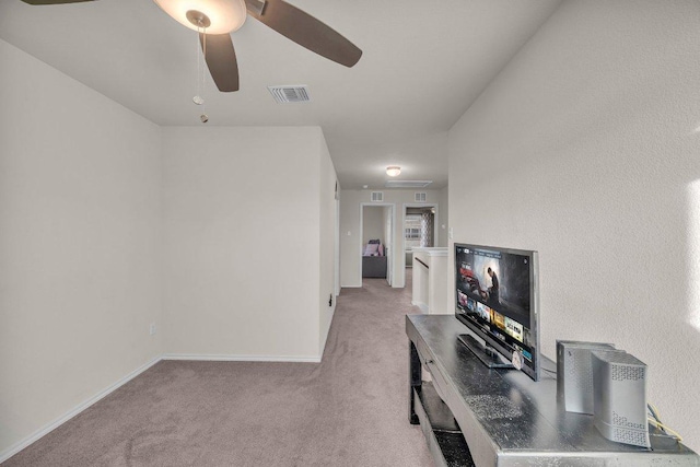 office space featuring light carpet, visible vents, baseboards, and ceiling fan