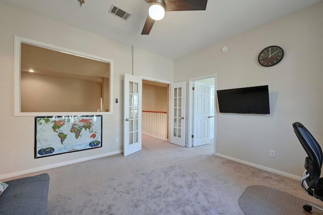 unfurnished office with a ceiling fan, carpet flooring, french doors, and visible vents
