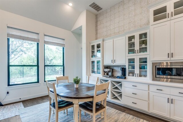 22306 Cape Travis Bnd, Lago Vista, TX 78645 - dining area with visible vents, light wood-style flooring, and baseboards