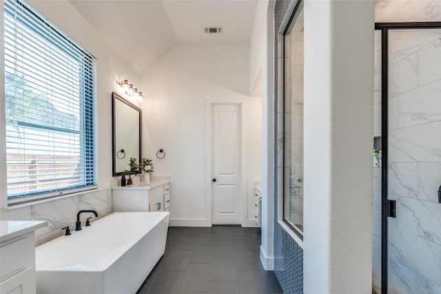 22306 Cape Travis Bnd, Lago Vista, TX 78645 - bathroom featuring visible vents, vaulted ceiling, a stall shower, a freestanding tub, and vanity