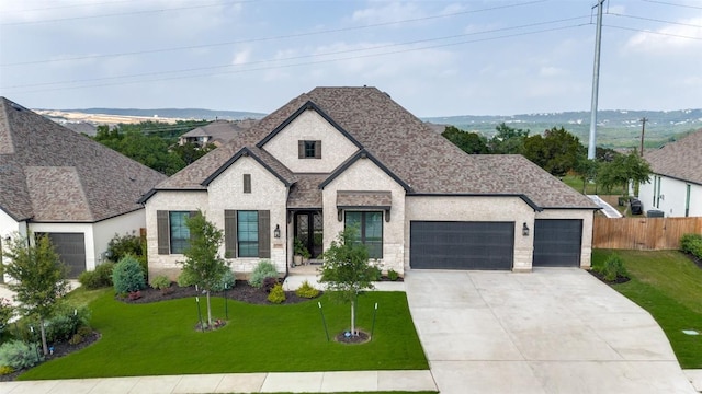 22306 Cape Travis Bnd, Lago Vista, TX 78645 - french country home featuring a front yard, a garage, driveway, and roof with shingles