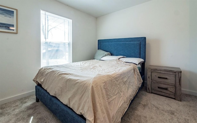 bedroom with baseboards and carpet