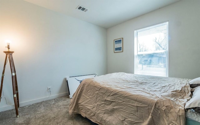 carpeted bedroom with visible vents and baseboards