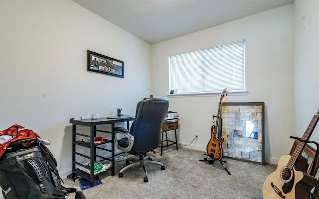 carpeted home office featuring baseboards