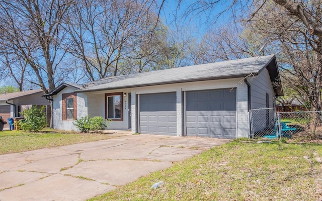 single story home featuring a front yard, fence, driveway, a garage, and brick siding