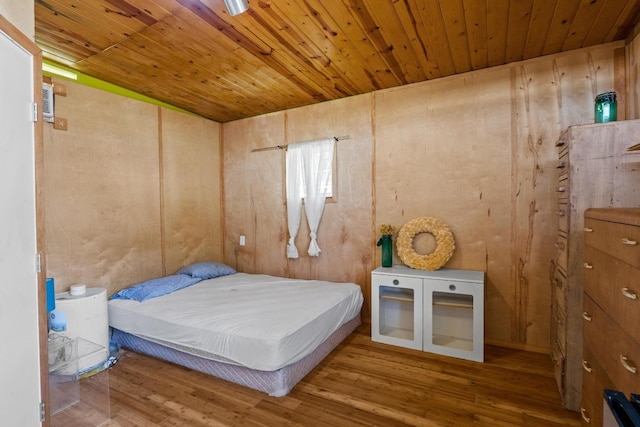 unfurnished bedroom with wooden ceiling and wood finished floors