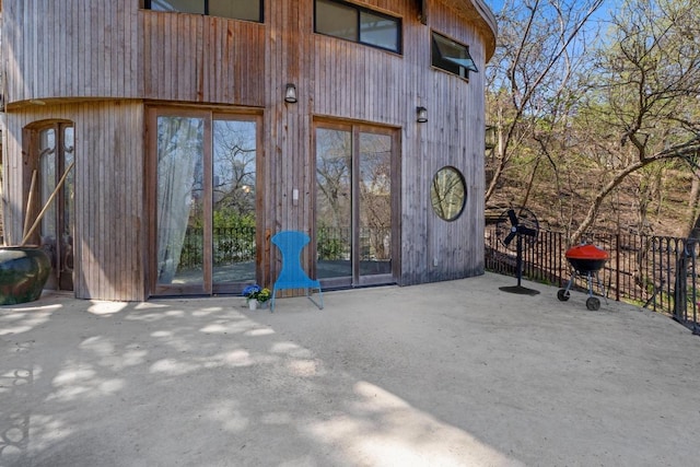 view of exterior entry with a patio