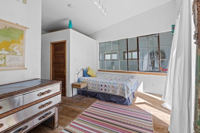 bedroom featuring vaulted ceiling and wood finished floors