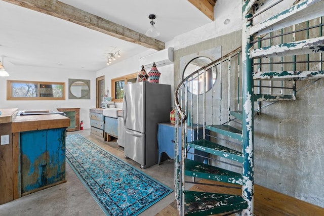 staircase featuring beam ceiling, an AC wall unit, and concrete flooring