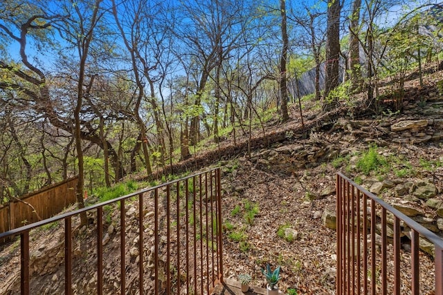 view of yard with a view of trees and fence