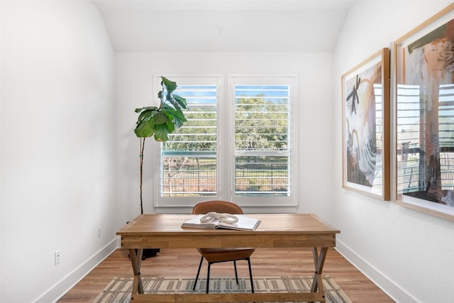 office space featuring baseboards and wood finished floors