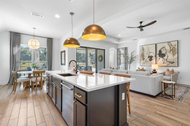 kitchen featuring visible vents, light wood-style flooring, recessed lighting, a sink, and light countertops