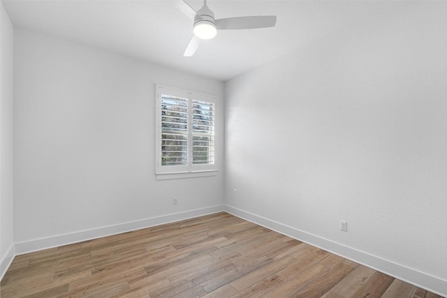 empty room featuring a ceiling fan, light wood-type flooring, and baseboards