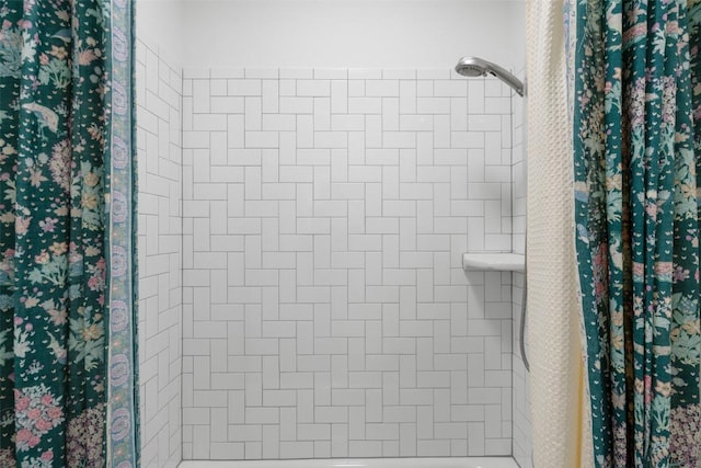 full bathroom with tiled shower