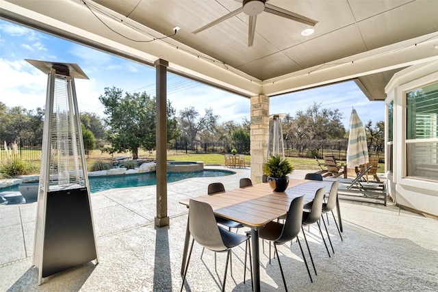 view of patio / terrace with outdoor dining space, a pool with connected hot tub, ceiling fan, and fence