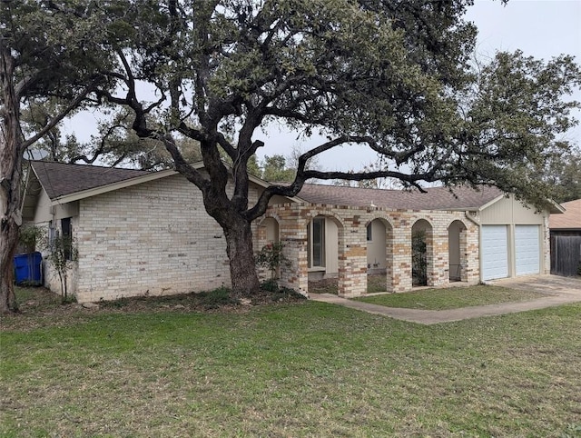 view of front of property featuring brick siding, a front lawn, concrete driveway, roof with shingles, and a garage