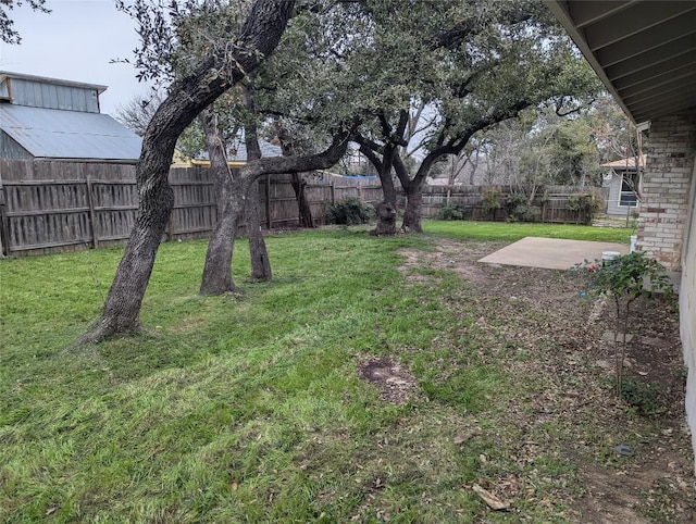 view of yard with a fenced backyard and a patio area