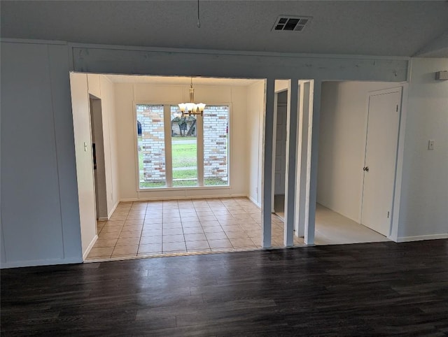 unfurnished dining area with an inviting chandelier, visible vents, and light wood-type flooring