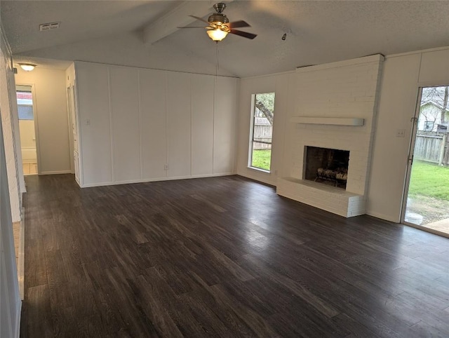 unfurnished living room featuring dark wood finished floors, a fireplace, vaulted ceiling with beams, and a ceiling fan